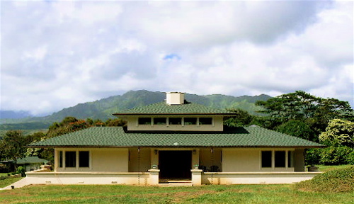 Clean symmetry defines the front of this classically inspired home. The house was carefully oriented to exactly align with the Makaleha Mountains visible in the background.