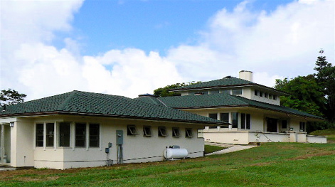 The detached garage continues the themes developed by the main house with mitered glass corner windows in the workroom end, and a string of five tiny windows providing light and fresh air to the garage.