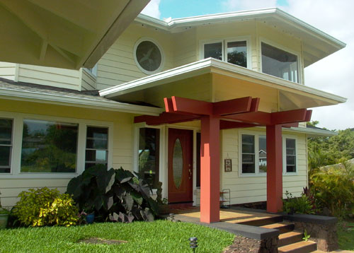 Front entry. Particular attention was paid to the strong sculptural form of the red 'Torii' or Japanese inspired gate over the entrance porch. An Asian influence is found in many DAK homes.